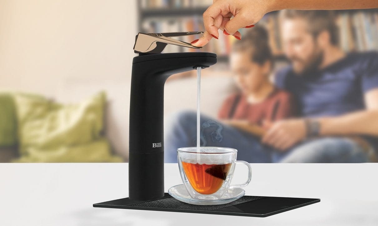 Matte Black dispenser filling tea cup with hot water