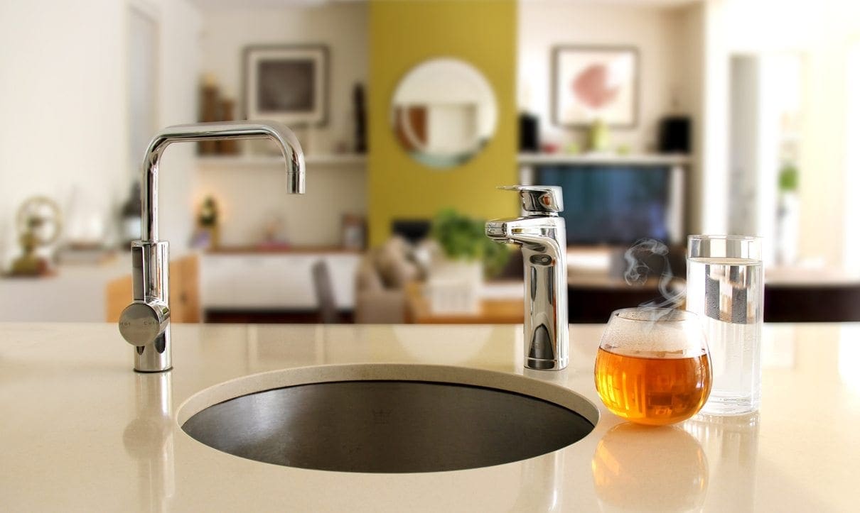 Bill Chrome XL dispenser on kitchen bench with cup of tea and glass of cold water