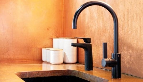 Billi XL Levered Dispenser in matt black with matching Gooseneck mixer on brass textured counter sink top and splash back