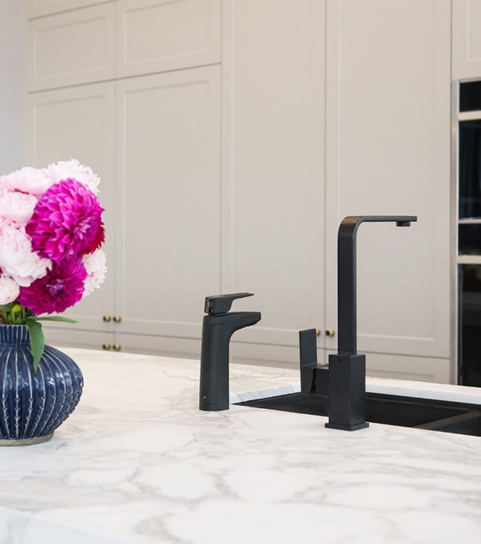 Matte Black dispenser on bench next to mixer tap