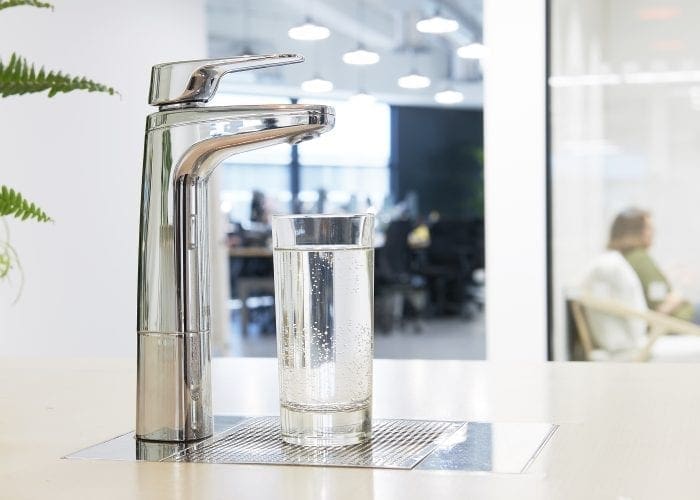 Billi XL Chrome dispenser on font and riser with glass of water