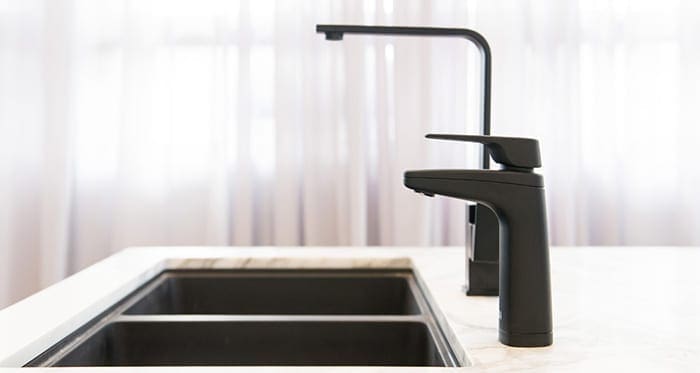 Billi XL dispenser in Matte black on kitchen bench next to mixer tap